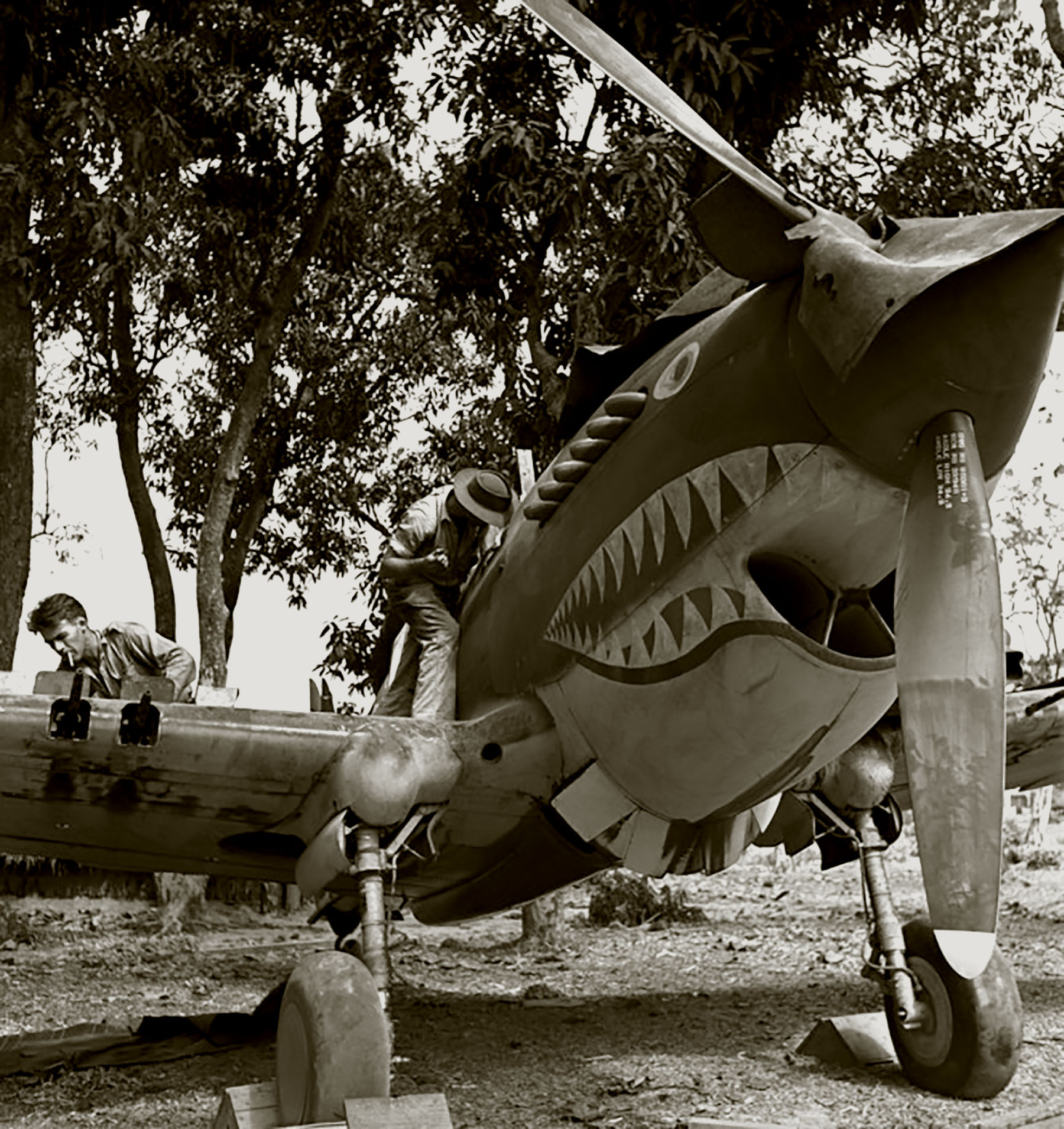 Armourers-Pat-Hanley-and-Jim-Musick-overhaul-cannons-on-a-Hawk-81A2-Mingladon-Rangoon-Burma-1942.jpg